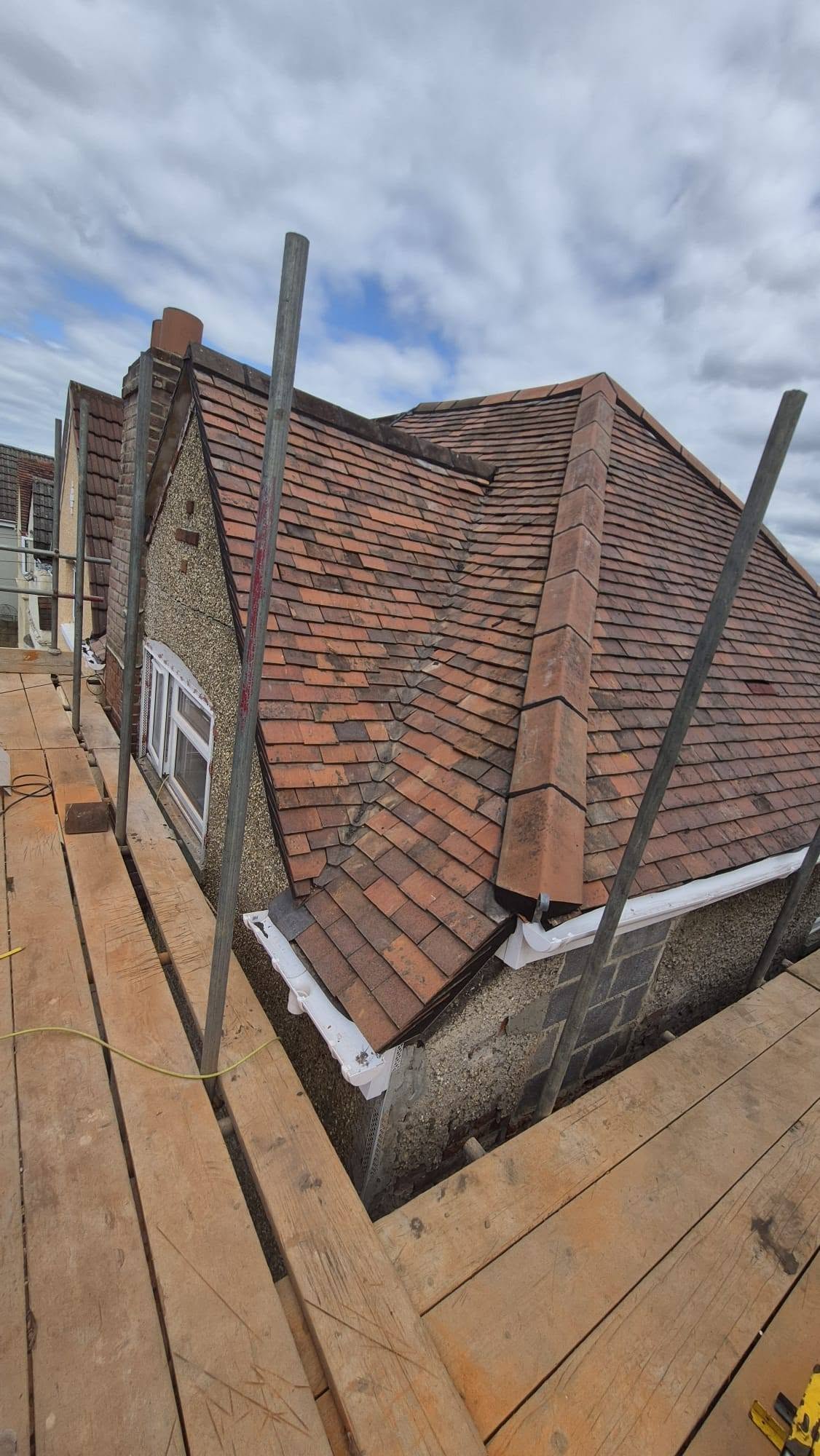 Clay plain-tile re-roof with a new hip ridge, up on the scaffold