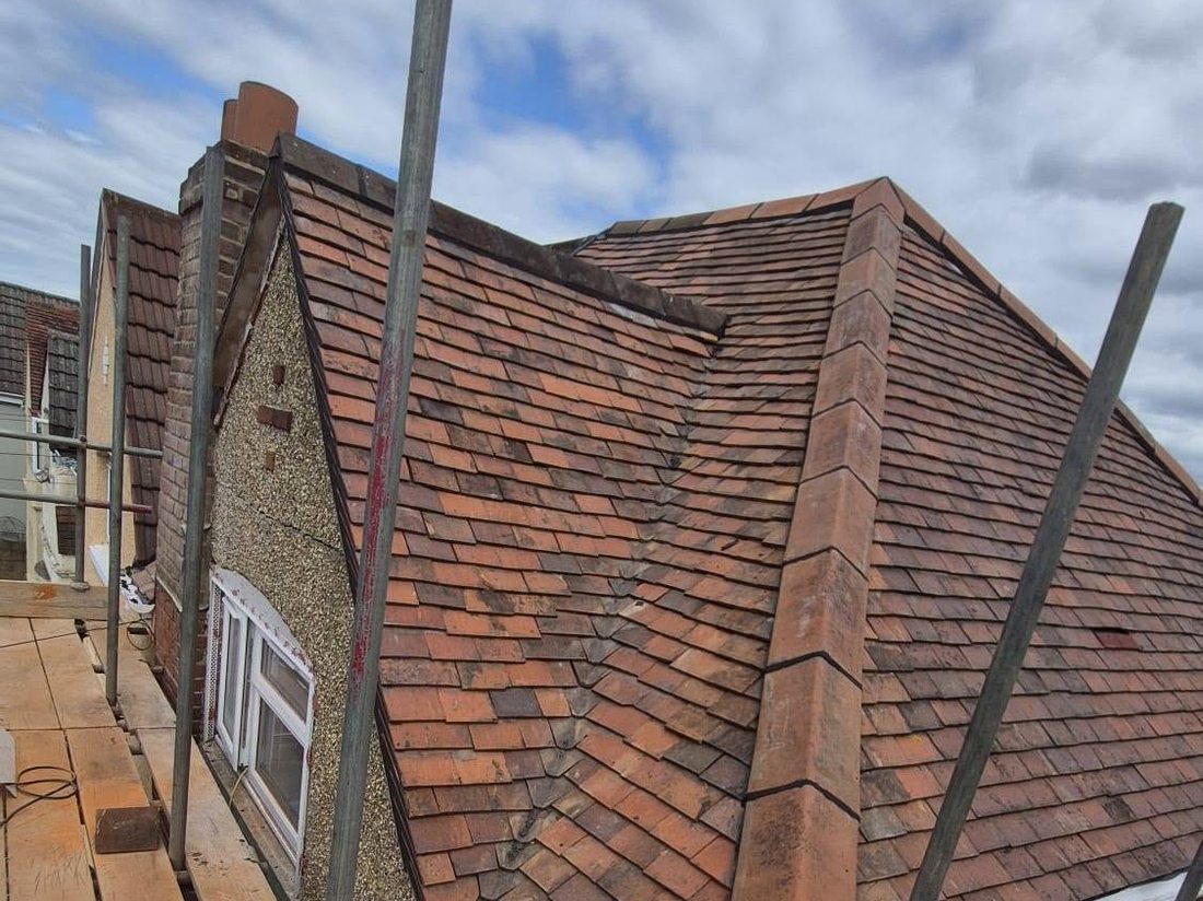 Full hipped re-roof in progress on scaffold by Shoreside Roofing